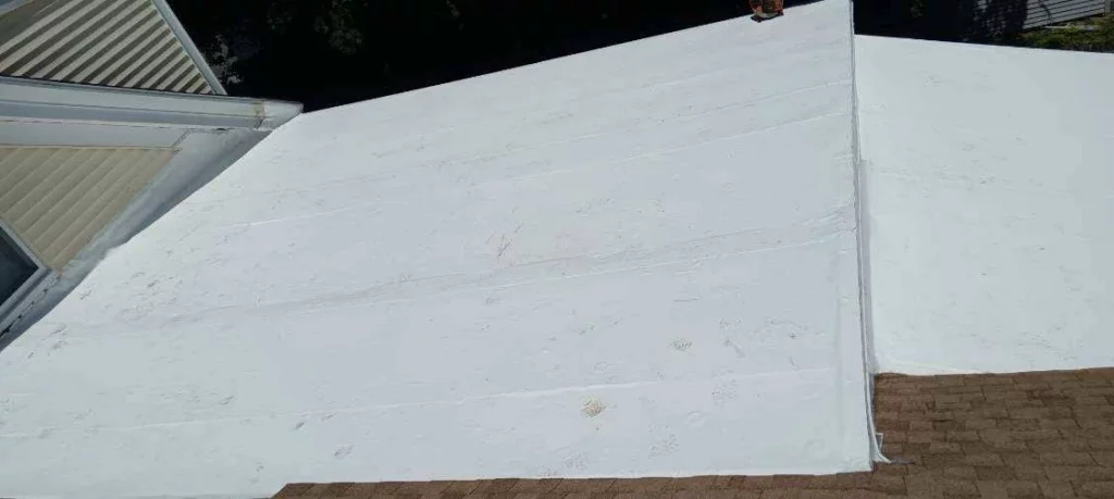 Visible junction between the shingles and PVC roof