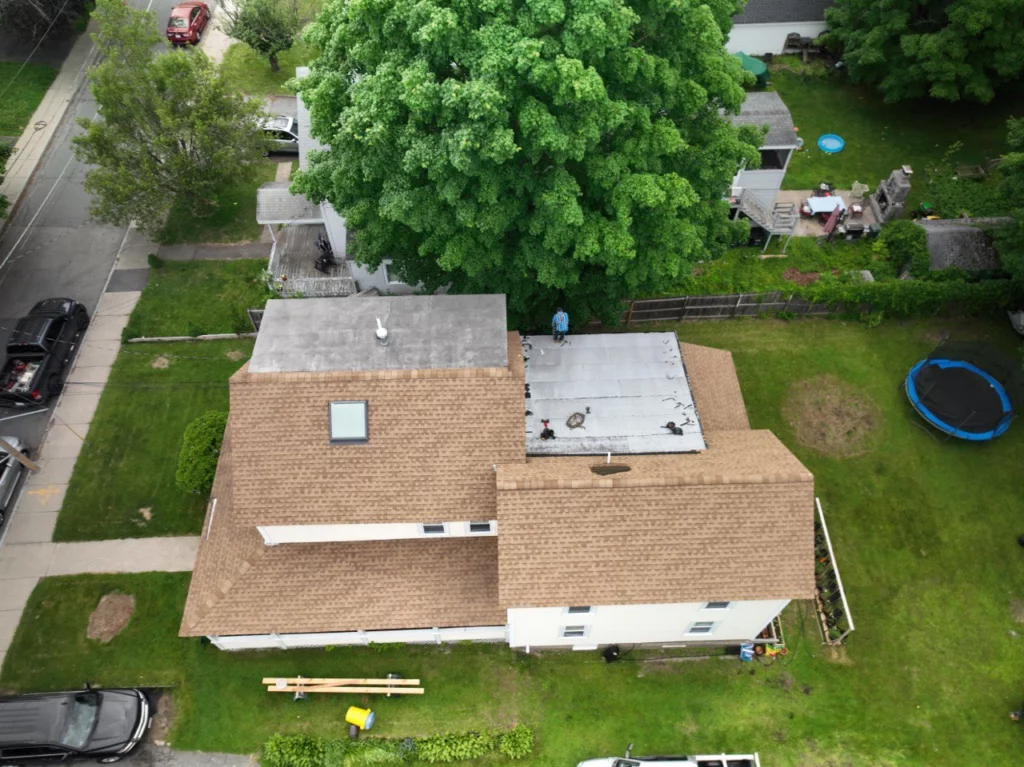 Ongoing roof replacement process: removing old materials and installing a new PVC flat roof