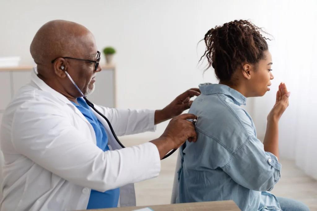 Doctor using a stethoscope to check a patient’s breathing