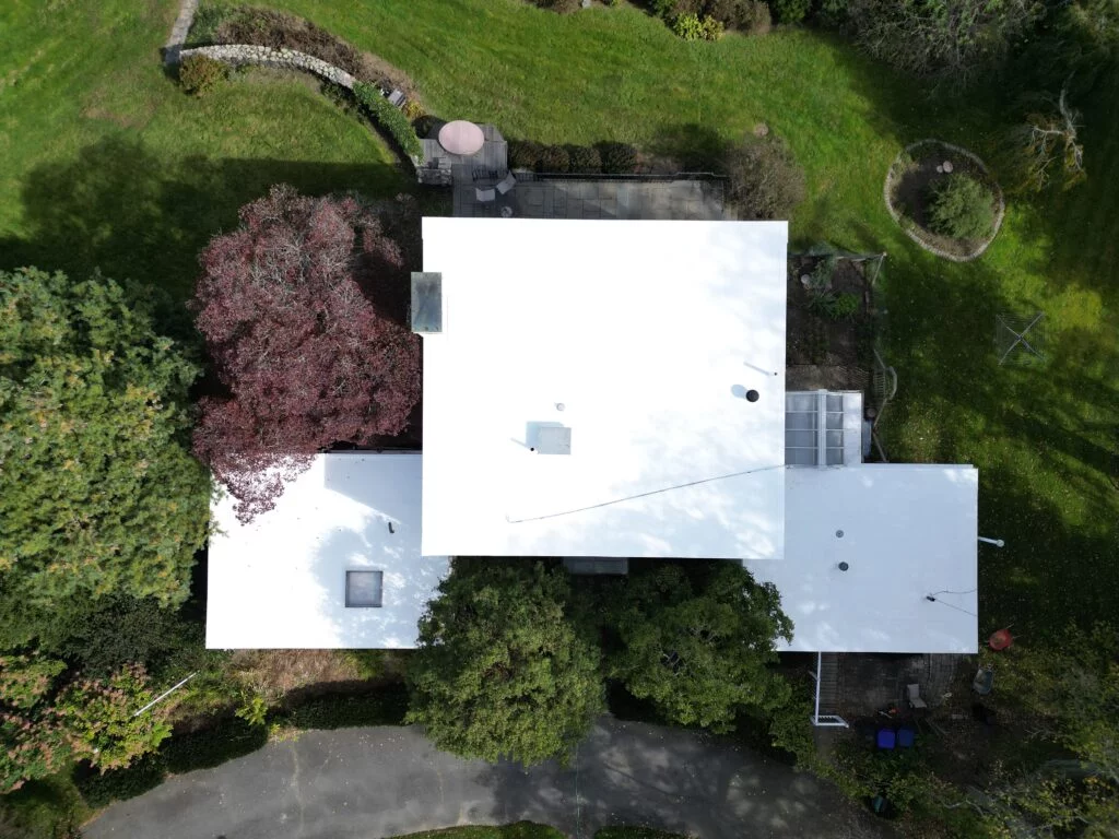 Drone perspective of the flat roof installed by ID Flat Roof at the property on 224 Adams St in Milton, Massachusetts