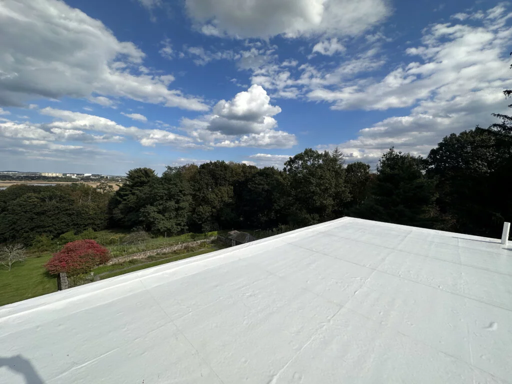 View of the completed PVC flat roof at 224 Adams St Milton Roofing, showcasing the scenic surroundings