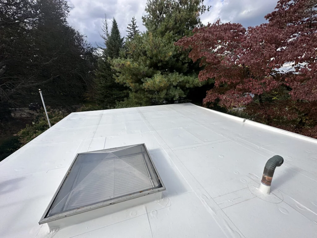 Close-up of the PVC roofing system with a skylight, recently installed at 224 Adams St