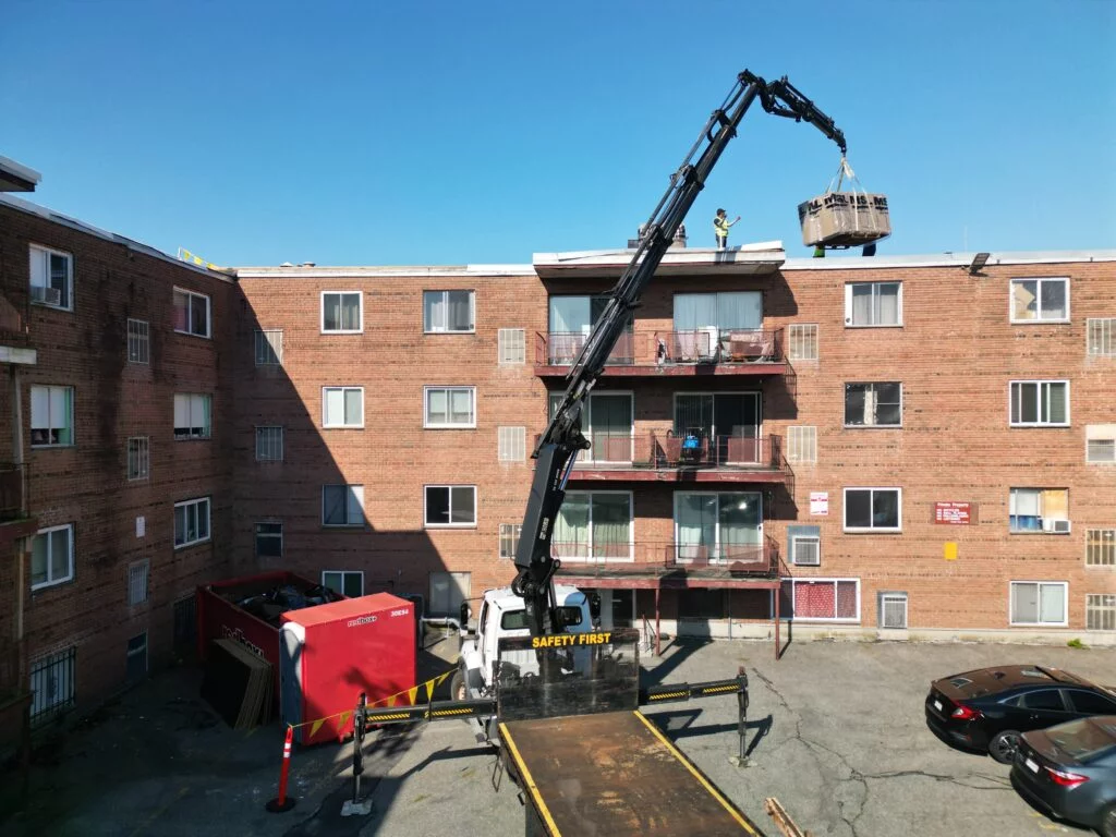 Crane assisting with material delivery: This method accelerated the 790 Hyde Park Ave project, minimizing disruption for residents.