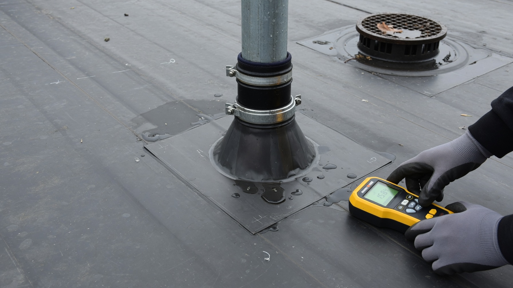 Moisture testing around a flat roof pipe penetration and flashing